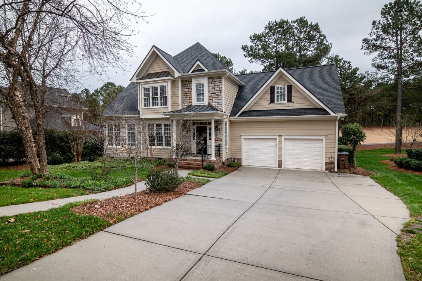 Suburban home with a long clean concrete driveway
